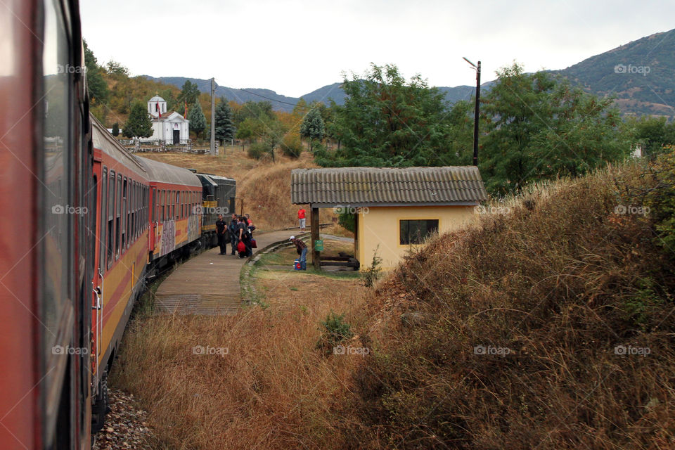 Passengers board a train in rural Macedonia