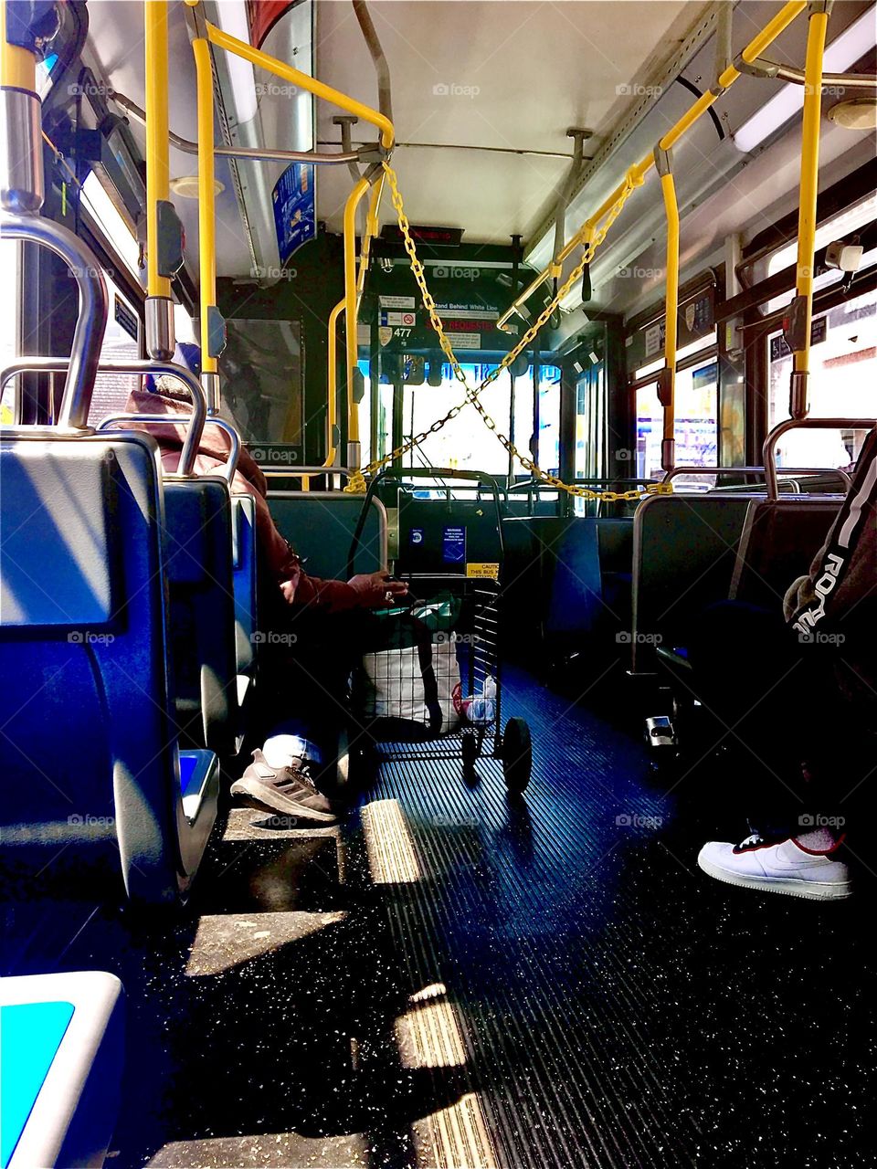 The inside of a New York City bus devoid of passengers with its multifaceted interwoven elemental structures makes a beautifully balanced composition worth photographing. 2019. Hypnotic Productions