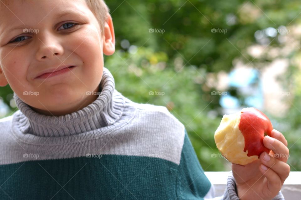 child boy with apple green background