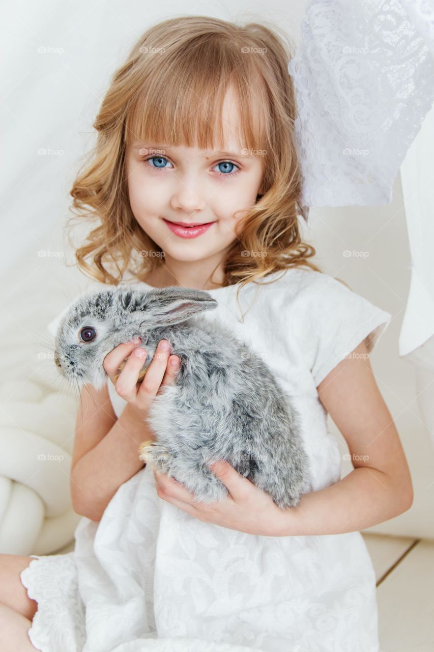 A beautiful baby with a rabbit....