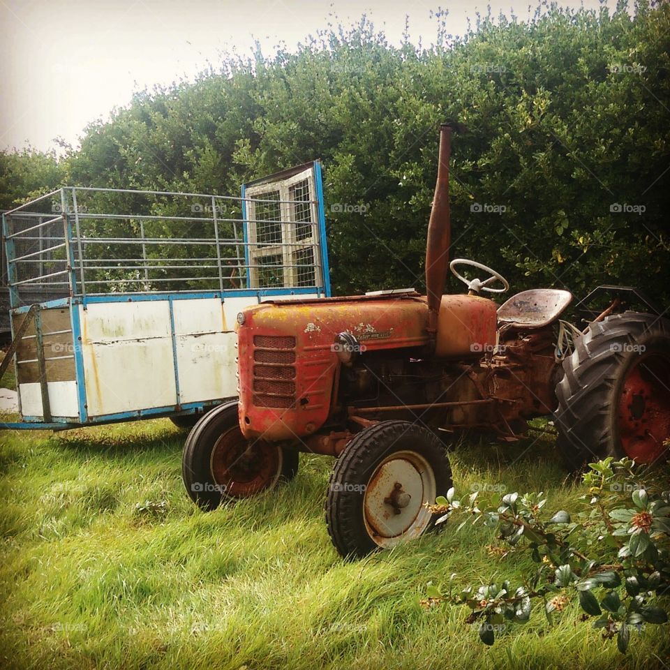 old tractor in field on summers day