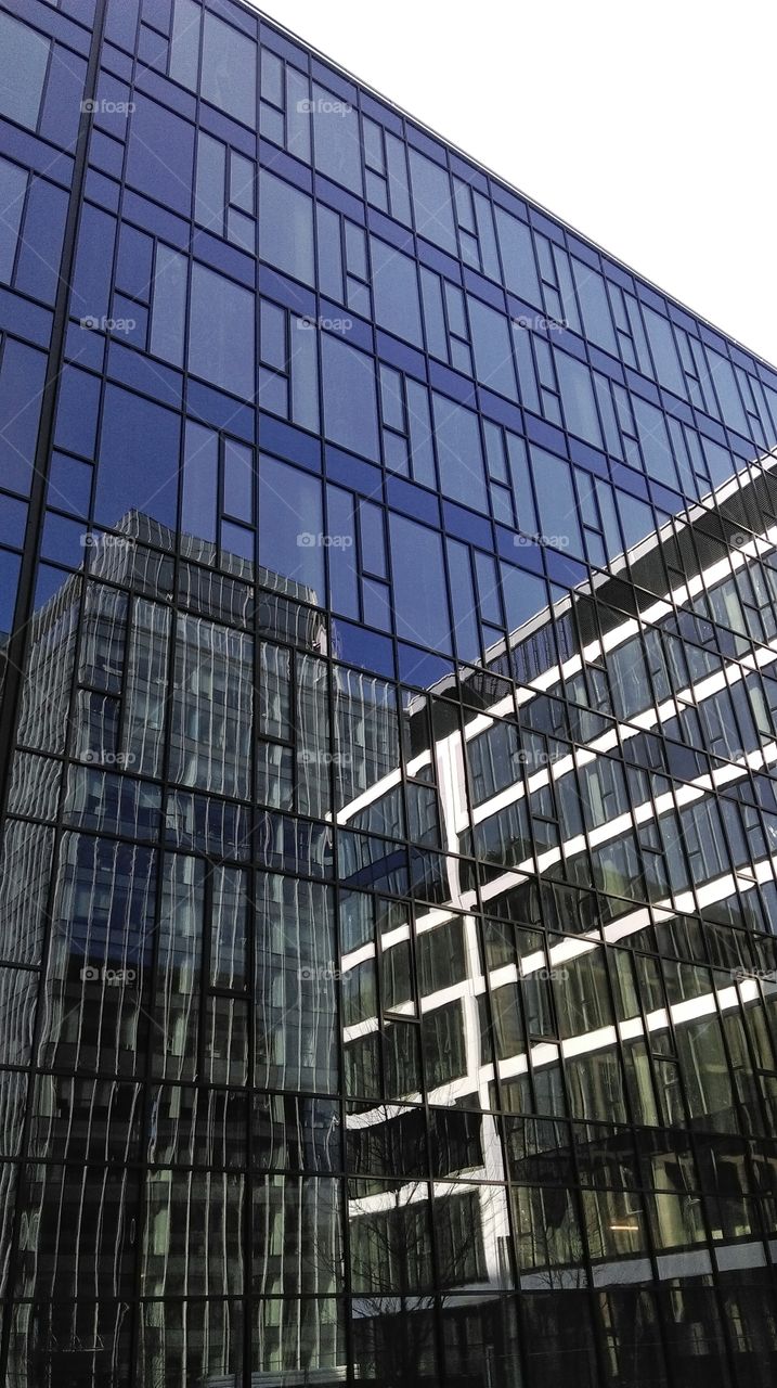 Reflections in windows of modern office building