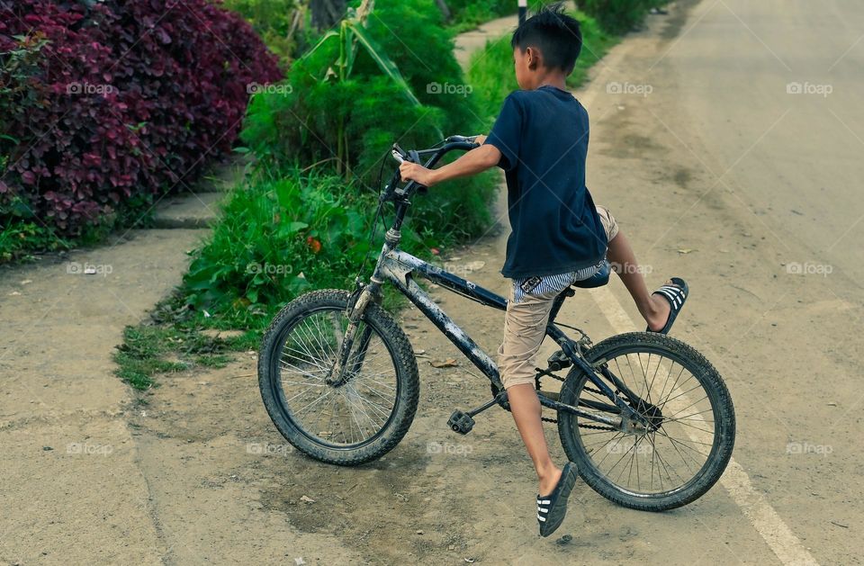 A kid enjoying his all terrain bicycle