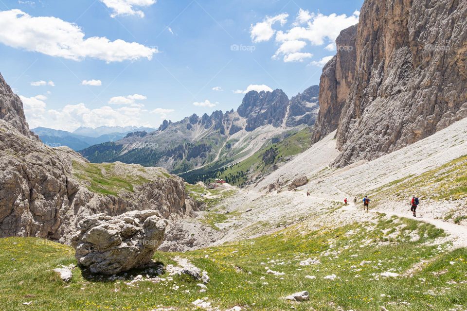 Hiking in the beautiful mountains of the Dolomites Italy on a sunny hot summer day 