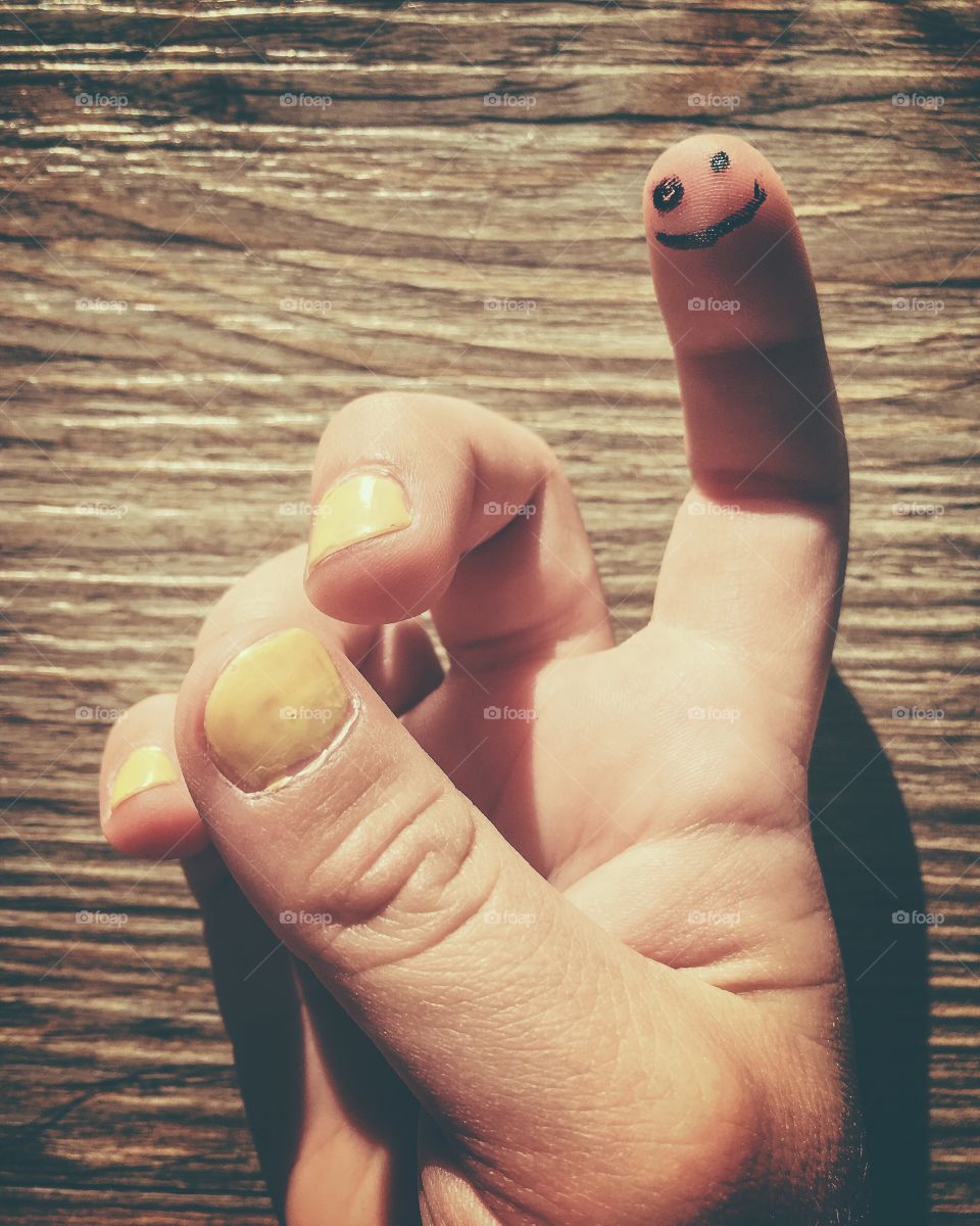 The hand of 4 year old girl, with a smiley on her finger.