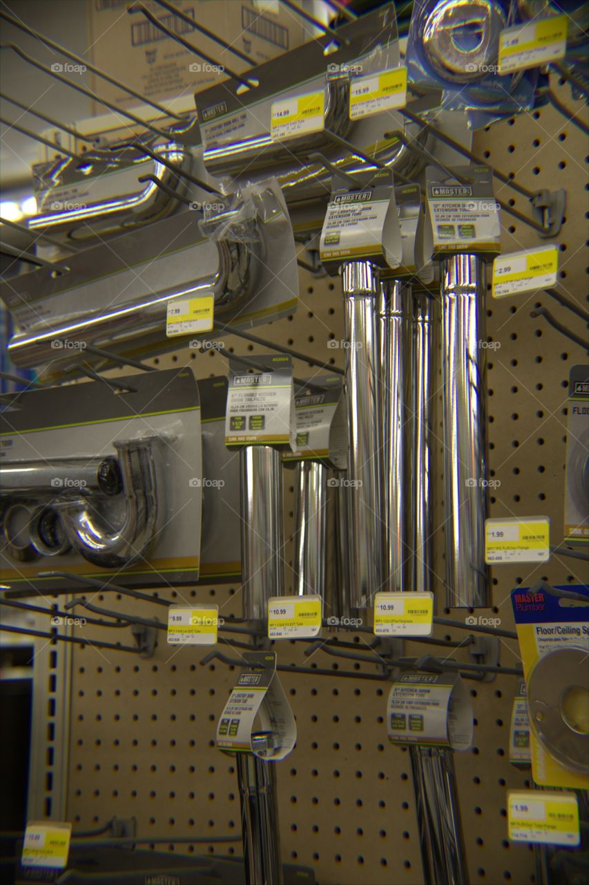 Plumbing Sink Extension Pipes Hanging on Pegboard