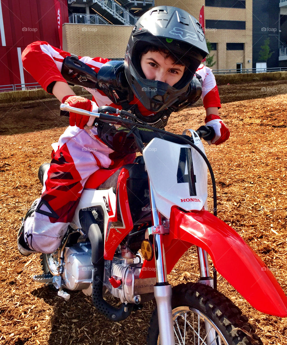 Kid riding on dirt bike with helmet  (boy) (Honda) 