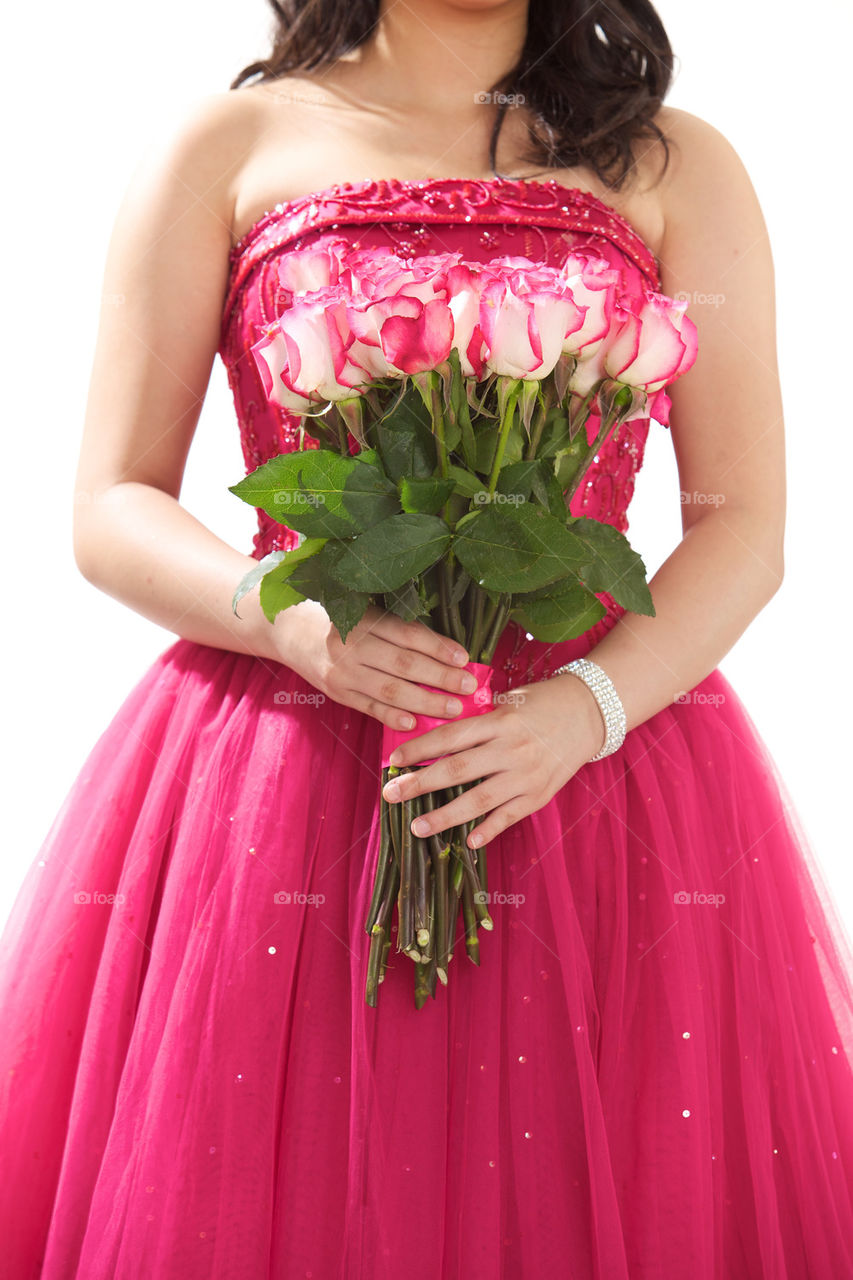 Flower girl holding roses bouquet, on pink magenta dress