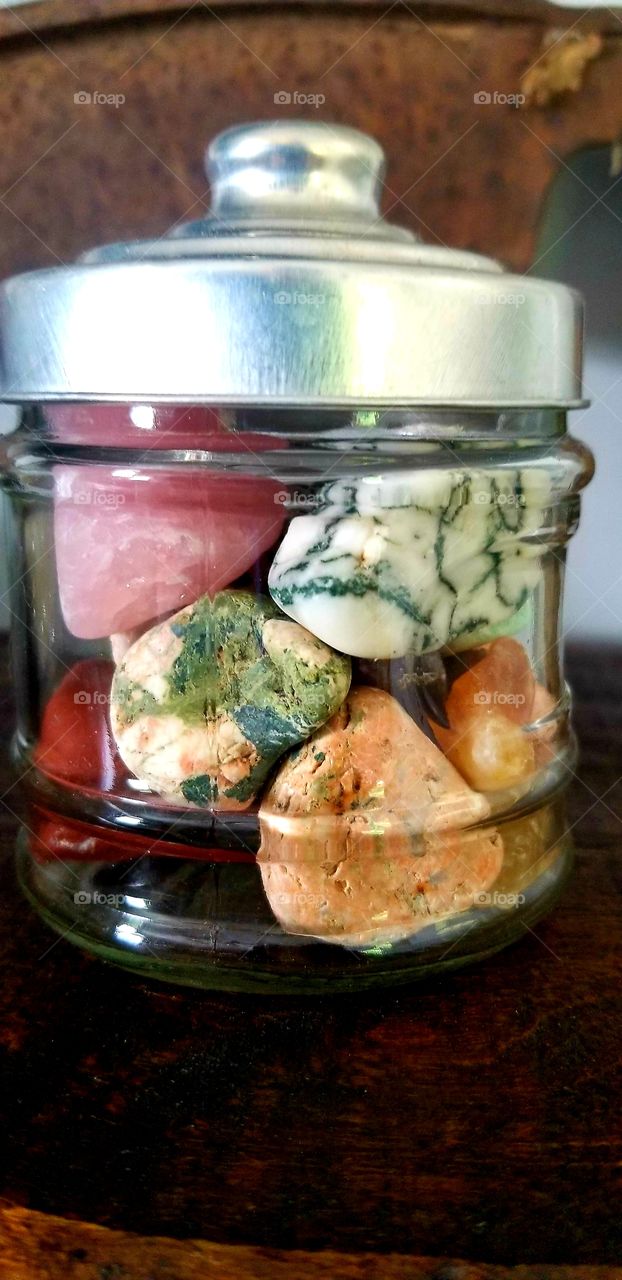 colorful gemstones in a glass jar