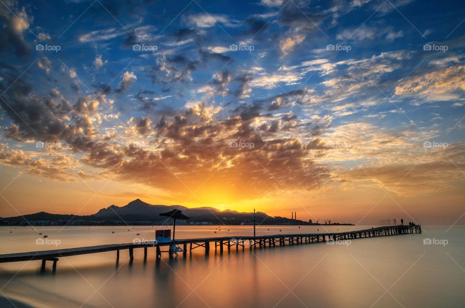 Pier on sea during sunset