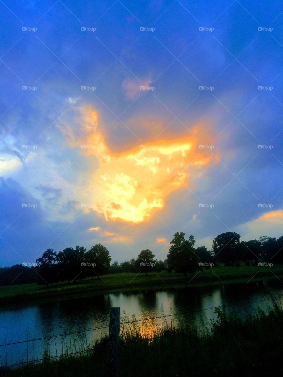 Sunset burst with pond reflection
