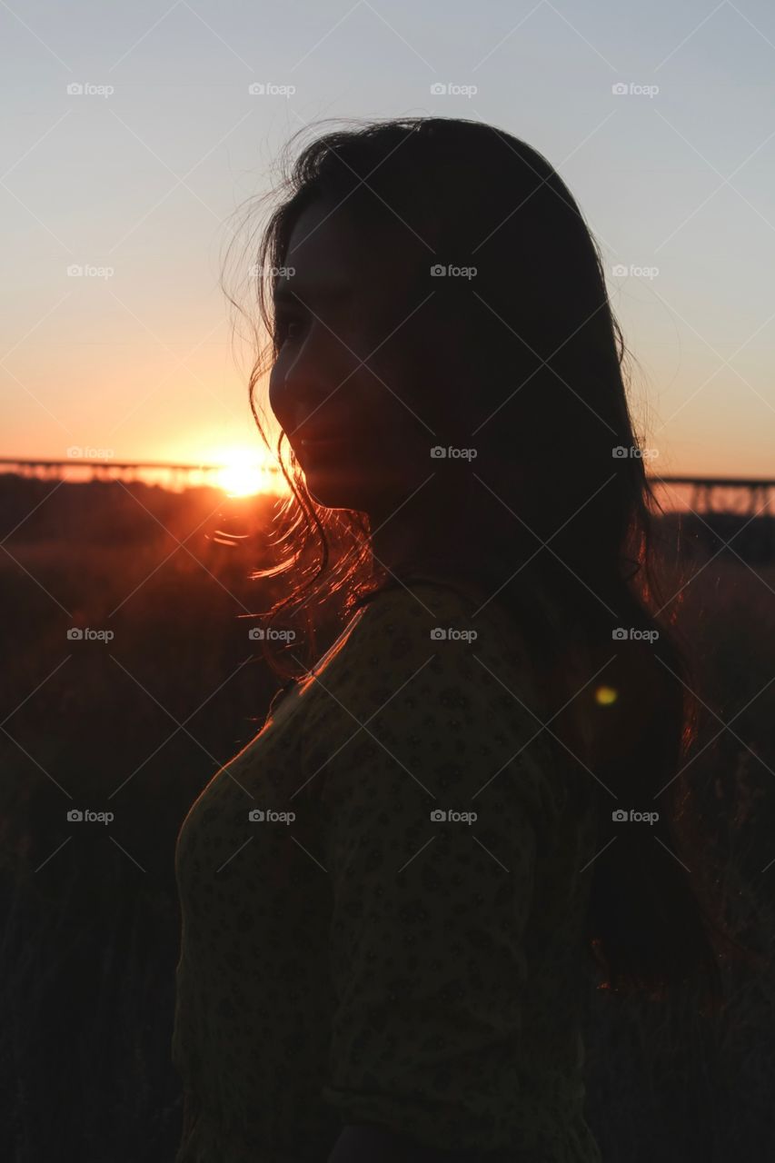 Beautiful woman in the golden sunset 