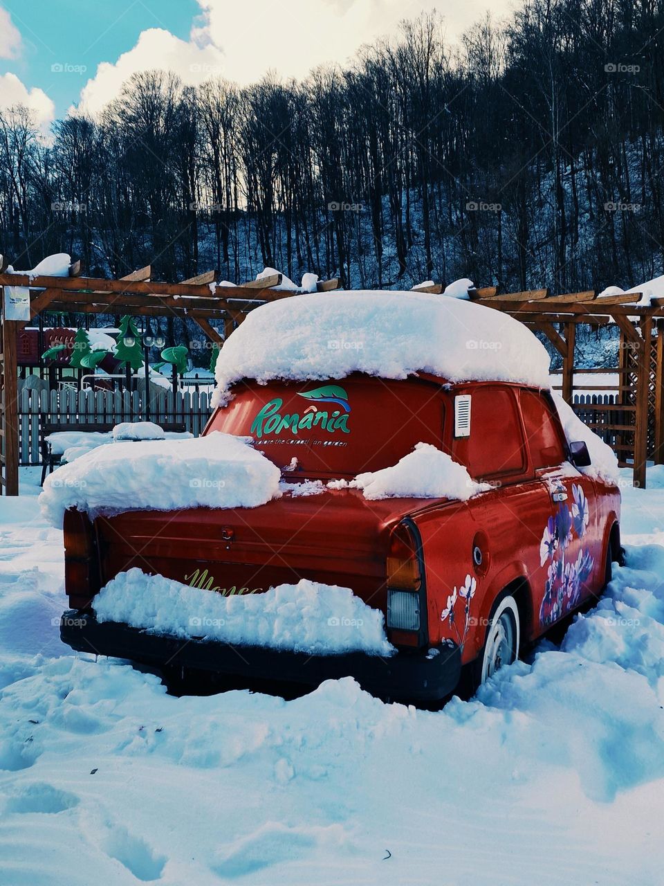 Red Trabant covered in snow