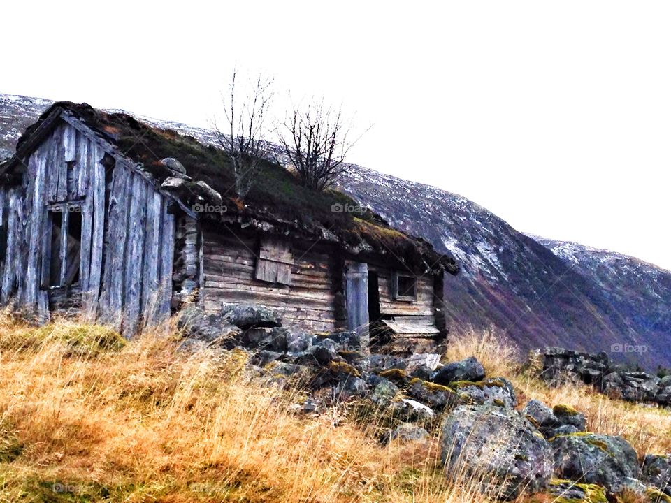 Scenic view of house against mountains