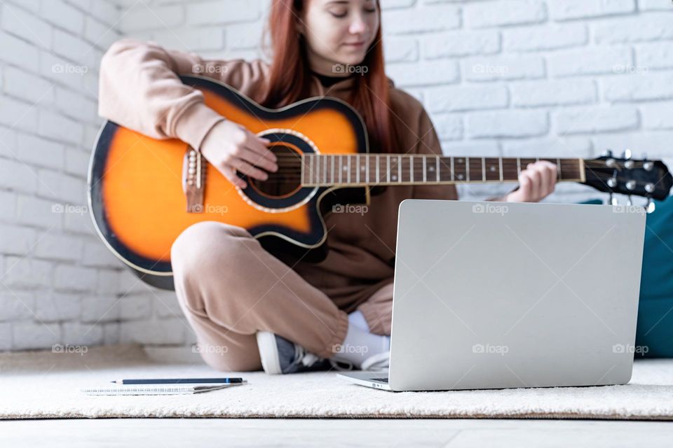 teen girl playing guitar