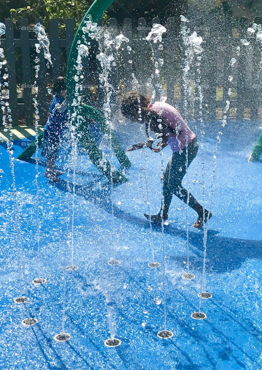 Child Running through fountain