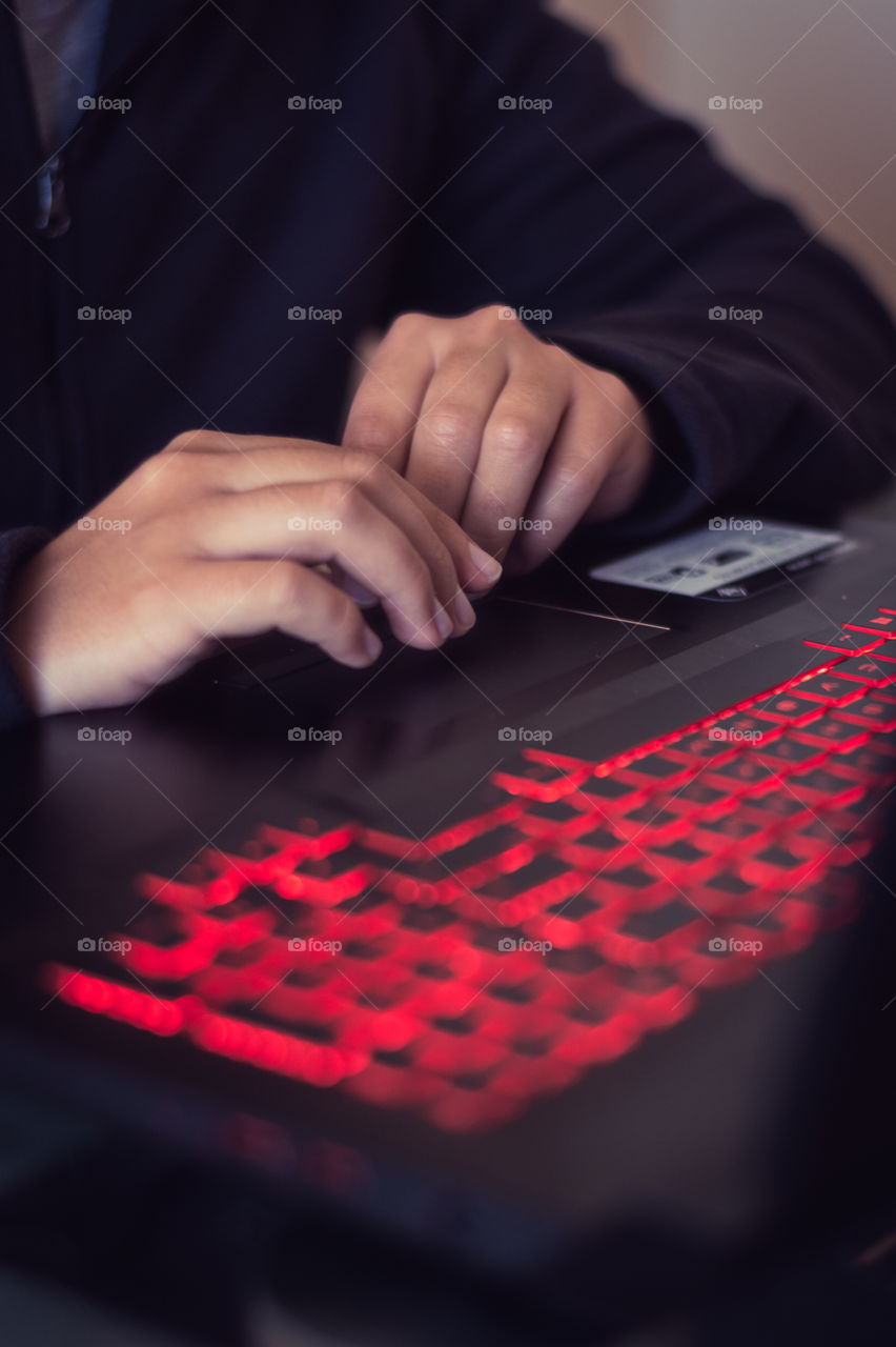 Hands of a man working in his laptop