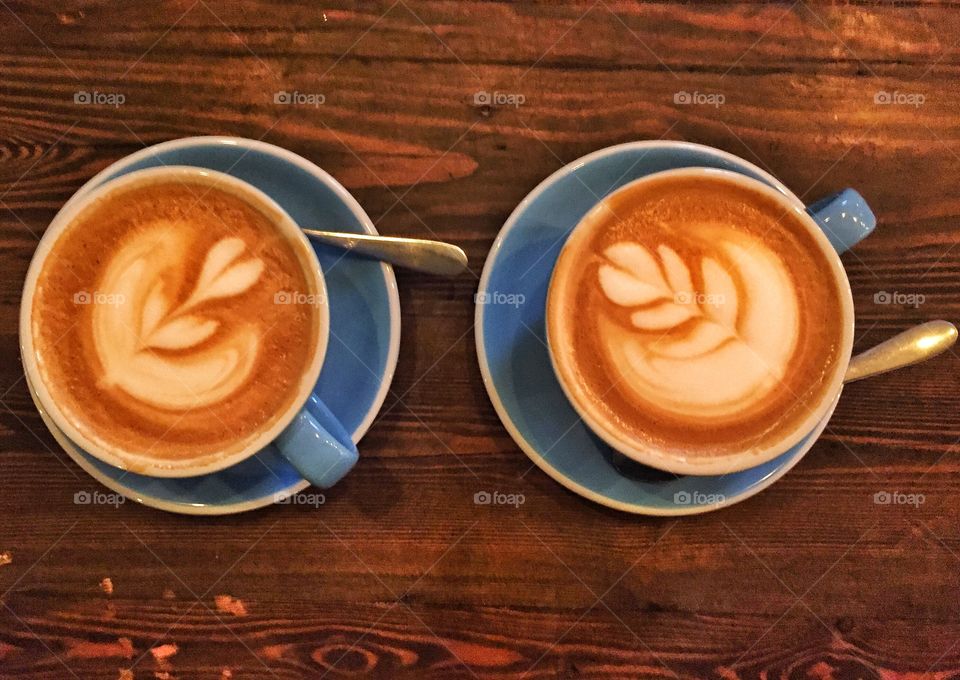 High angle view of coffee cups on wooden table