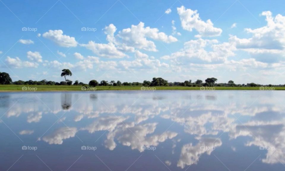 Blue sky reflection with clouds in the river