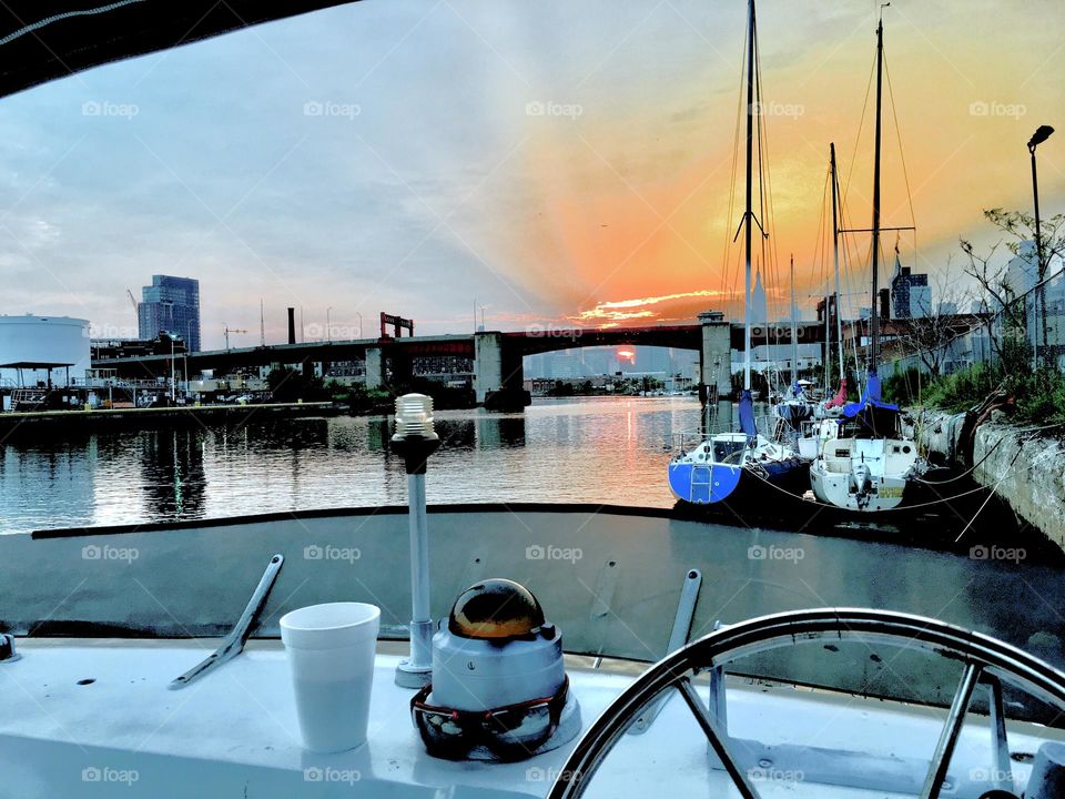 A view of the East River at Newtown Creek on an overcast late afternoon approaching sunset and twilight time. The Pulaski Bridge can be seen in the distance. 2019. Hypnotic Productions