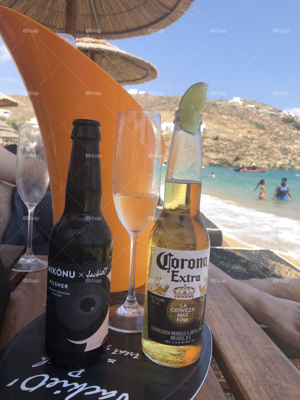 Beers and champagne served beachside or seaside in mykonos paradise beach jackie’ o