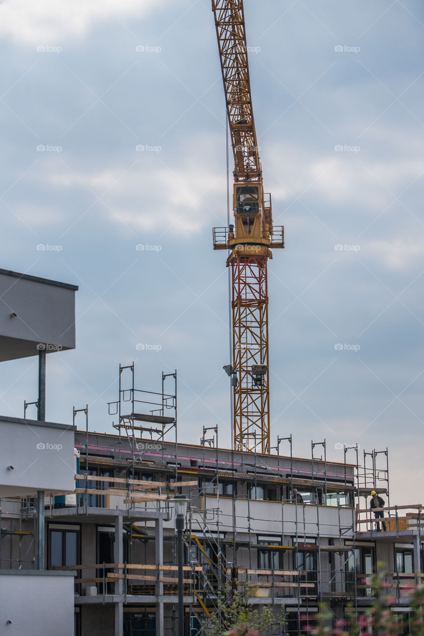 view of the construction site, scaffolding and crane