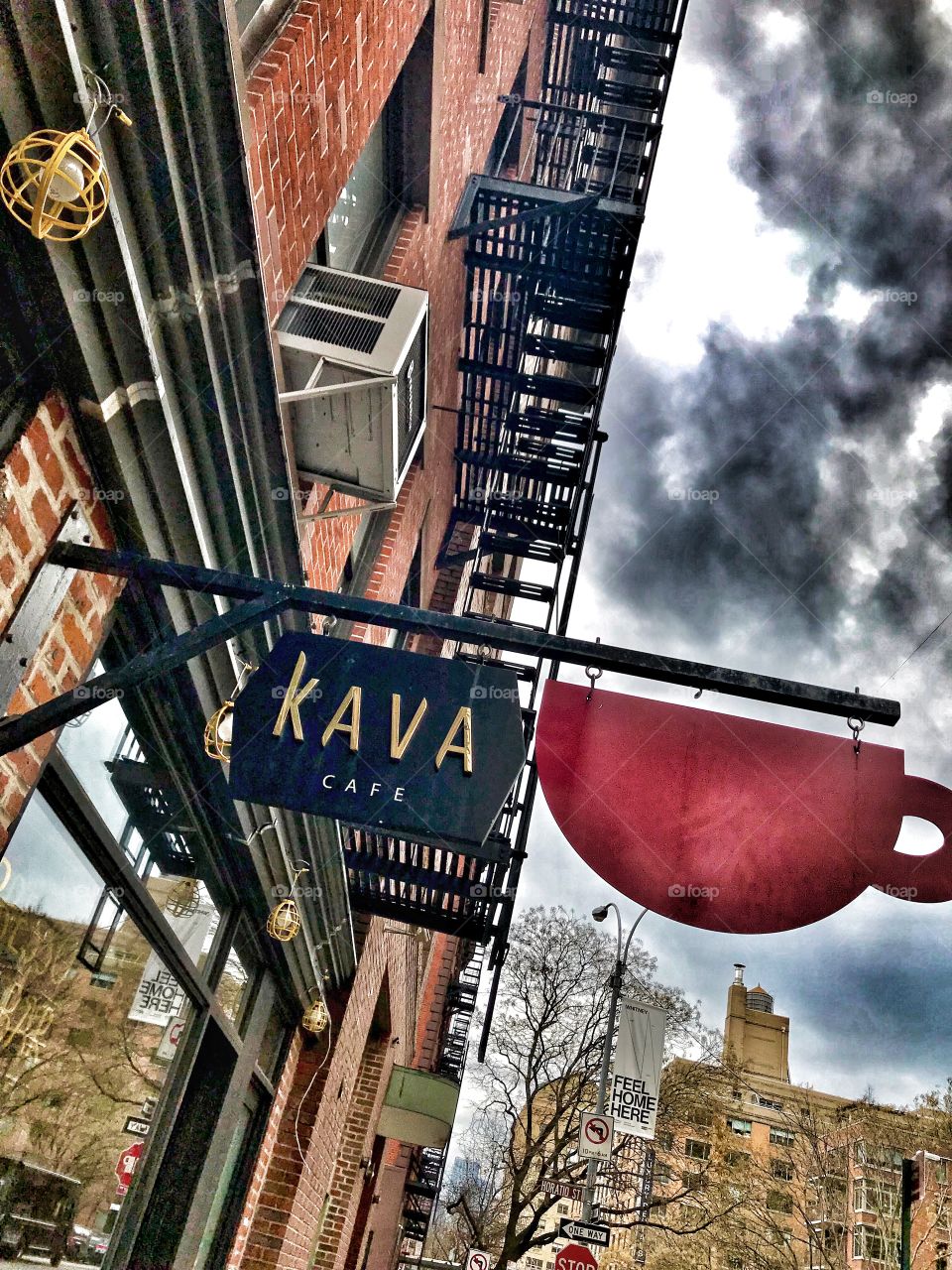 Coffee shop in Greenwich Village New York City. Clouds above look like steam coming out of coffee mug. 