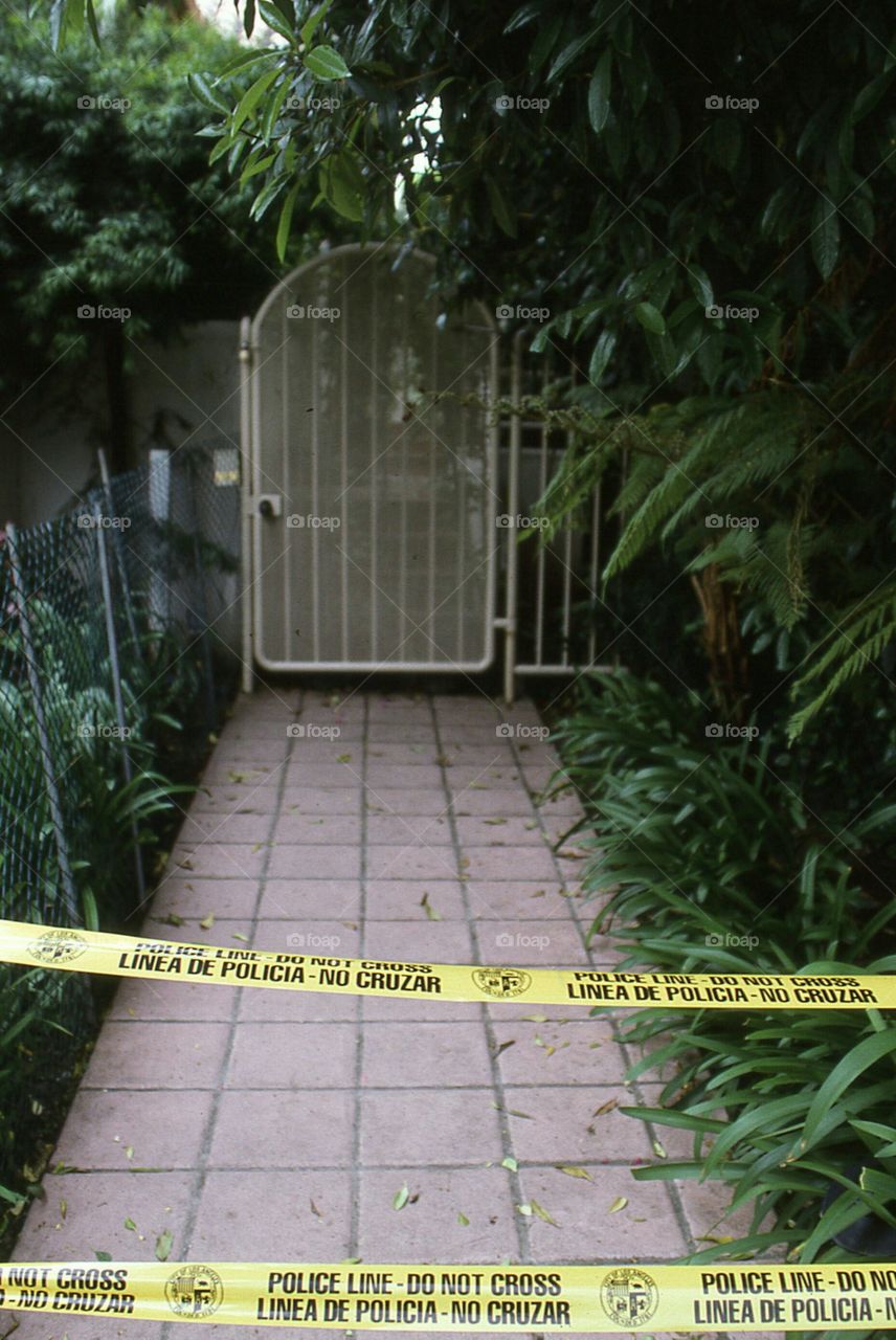 Nicole Brown Simpson's murder scene police tape walkway tropical gate