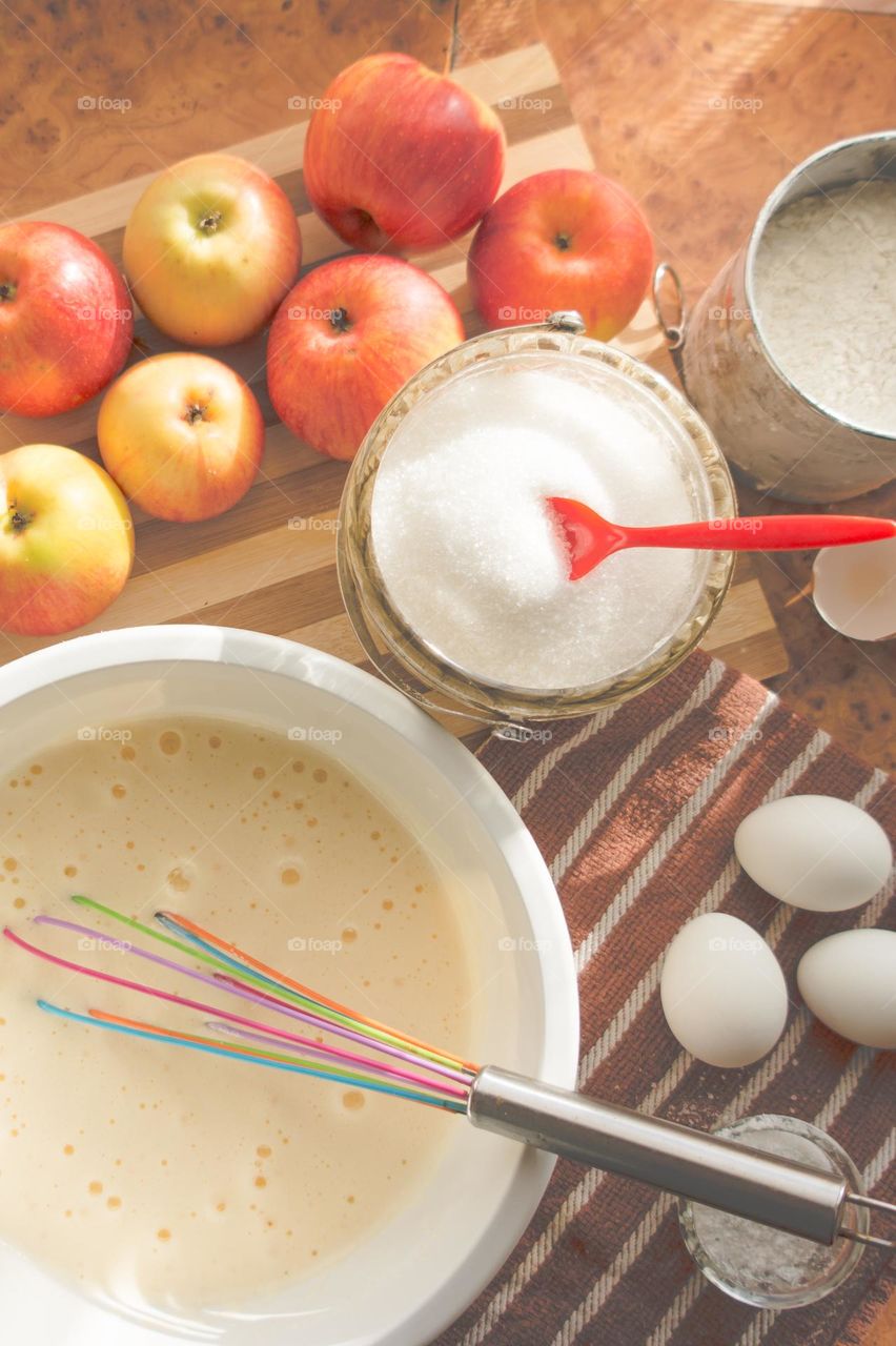Making homemade puffed apple pie with eggs, sugar and flour.