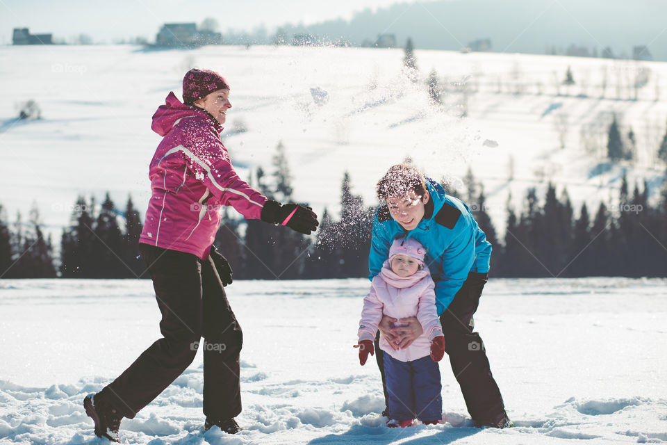 Mother playing with her children outdoors in the wintertime