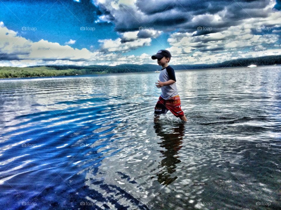 Boy walking in lake