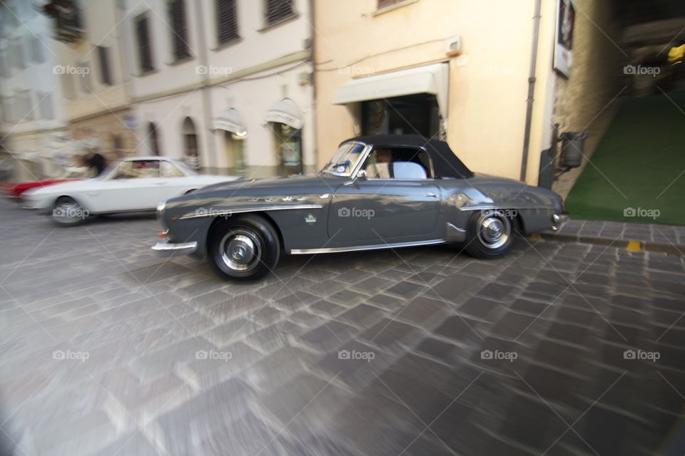 Close-up of retro cars parks in front of building