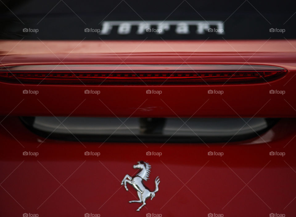 Back of a Ferrari race car and its logo