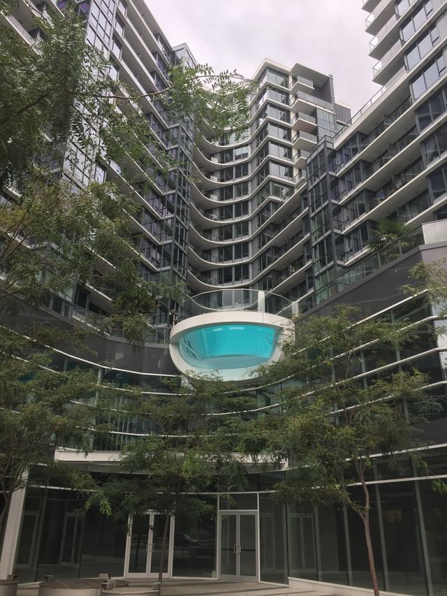 Bright blue swimming pool amongst the towering skyline of these downtown apartment buildings I. Vancouver, British Columbia 