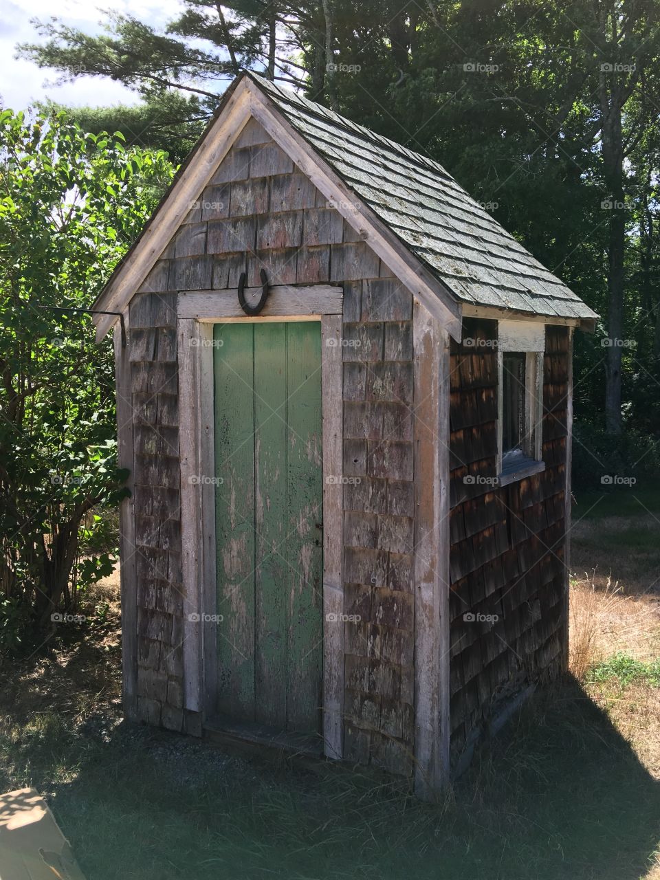 100 year old Outhouse In New England. This was in an old house's backyard, had to take the pic. Notice the horseshoe over the door? It's now going to be used as a shed for tools.