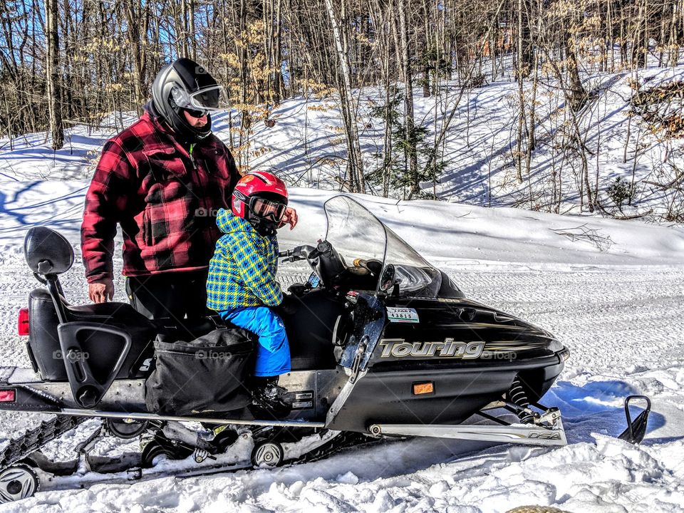 father and son snowmobiling