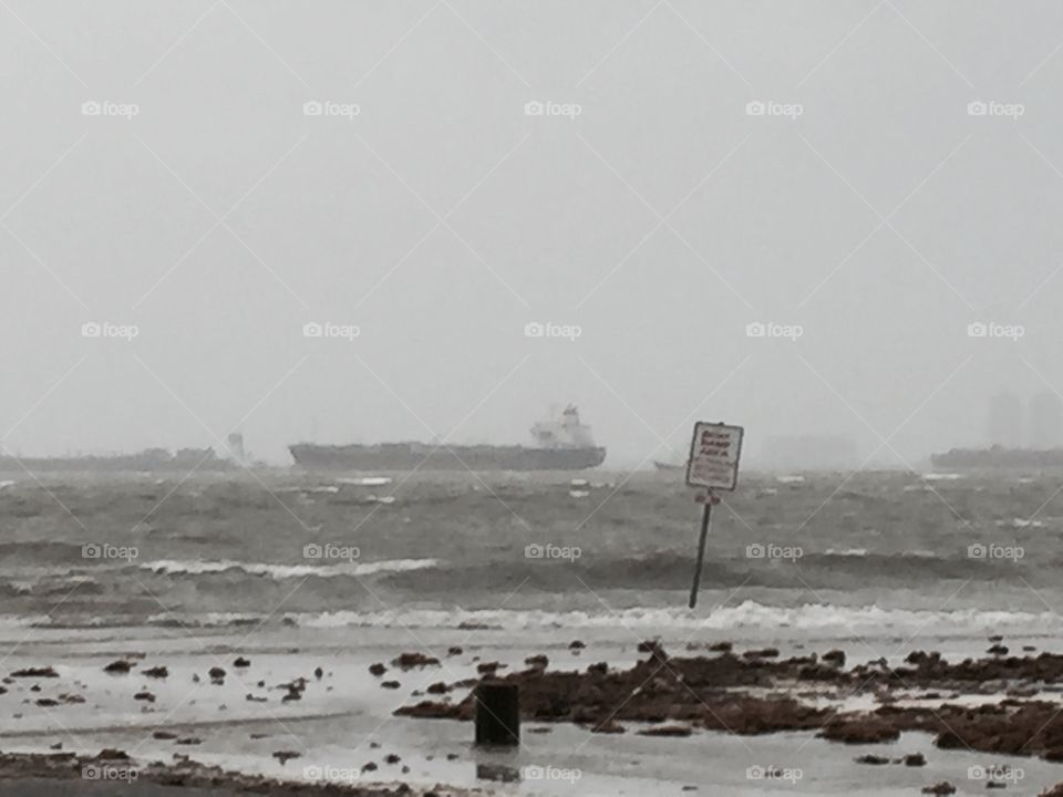 Ships anchored off Galveston during rough weather 