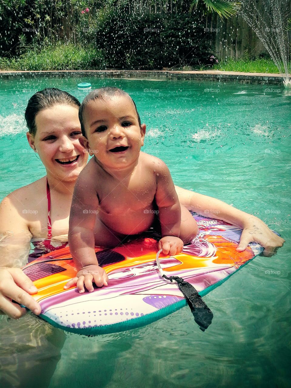 Mother with her son in swimming pool