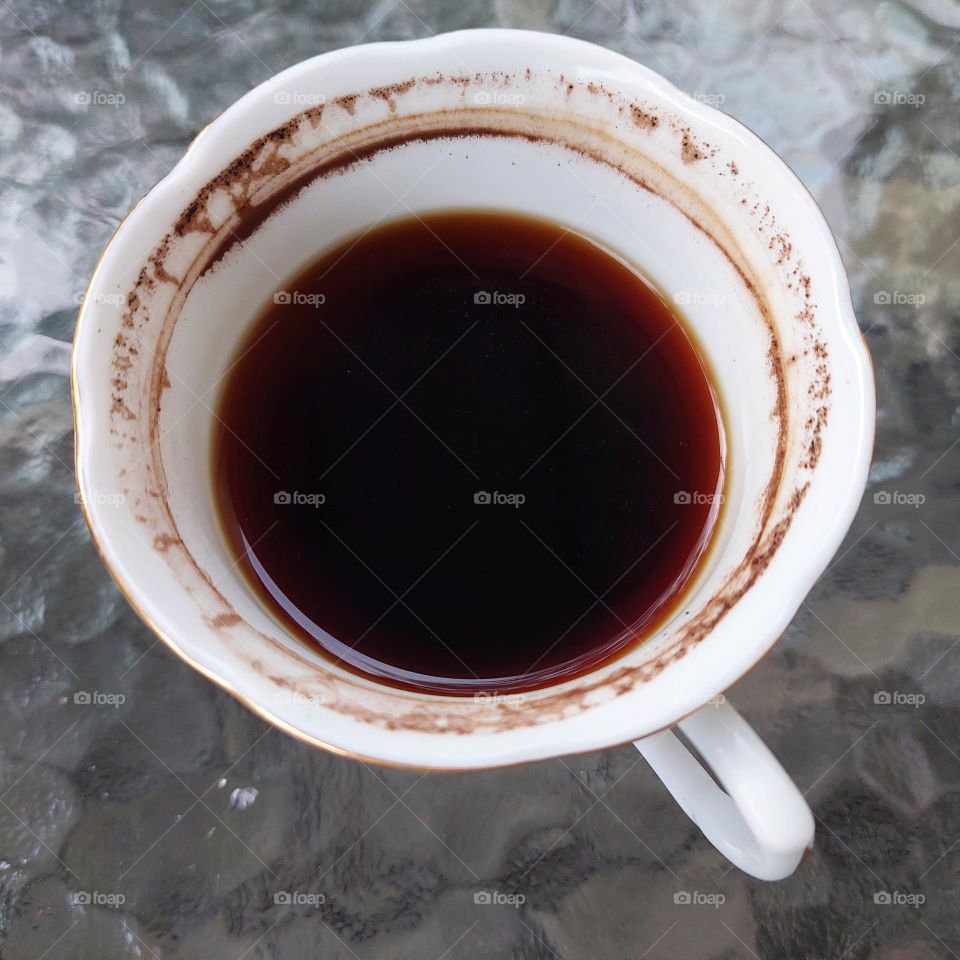 coffee in a partially drunk cup with traces of coffee on the edge of the cup