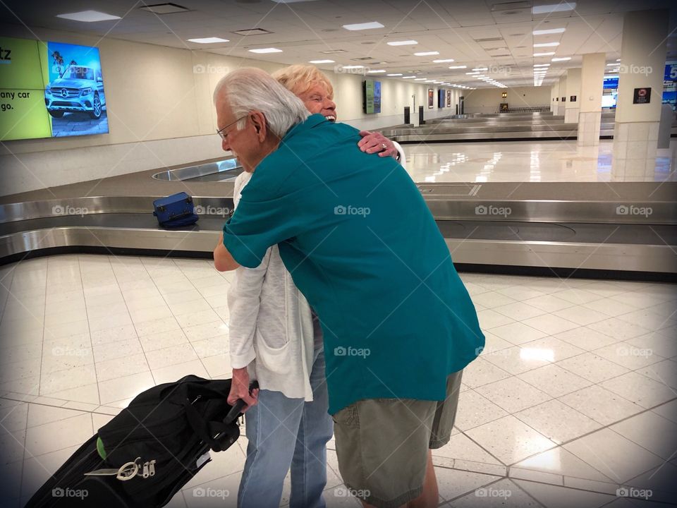 Mother and son in a warm embrace as they reunite at the airport.