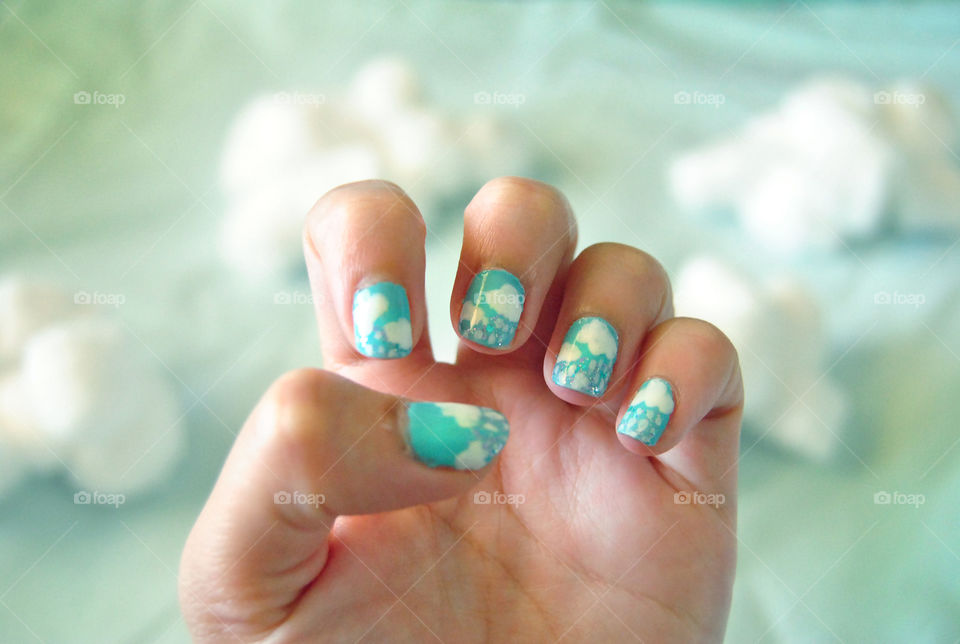 Clouds and rain nail art design with cotton balls as cloud background