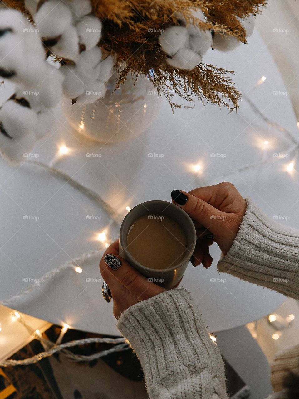 Holding cup of cofee with milk