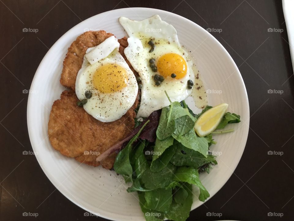 Fried egg and spinach in white plate