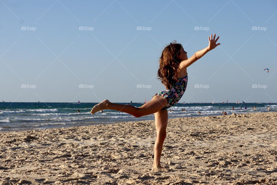 Girl dancing on the beach 