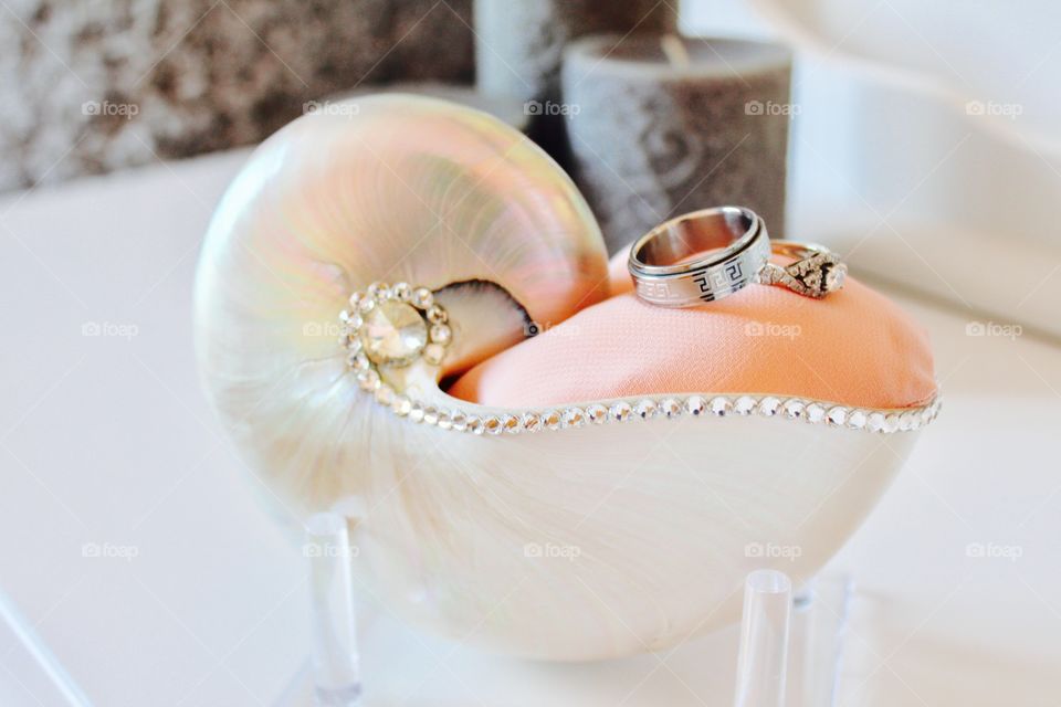 These are our gorgeous wedding rings on a shell ring holder 