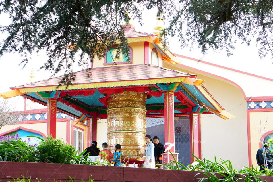 A group of Buddhism ringing the bell at Temple for their blessing 
California