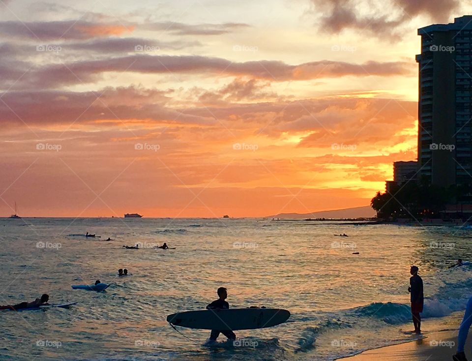A surfer calls it a day downtown Honolulu.  