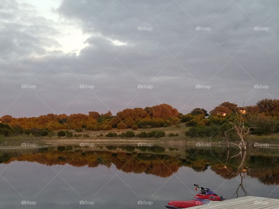 Another great reflection picture of our families lake while standing on the dock walkway. The setting sun created a beautiful orange hue over the distant cedar trees.