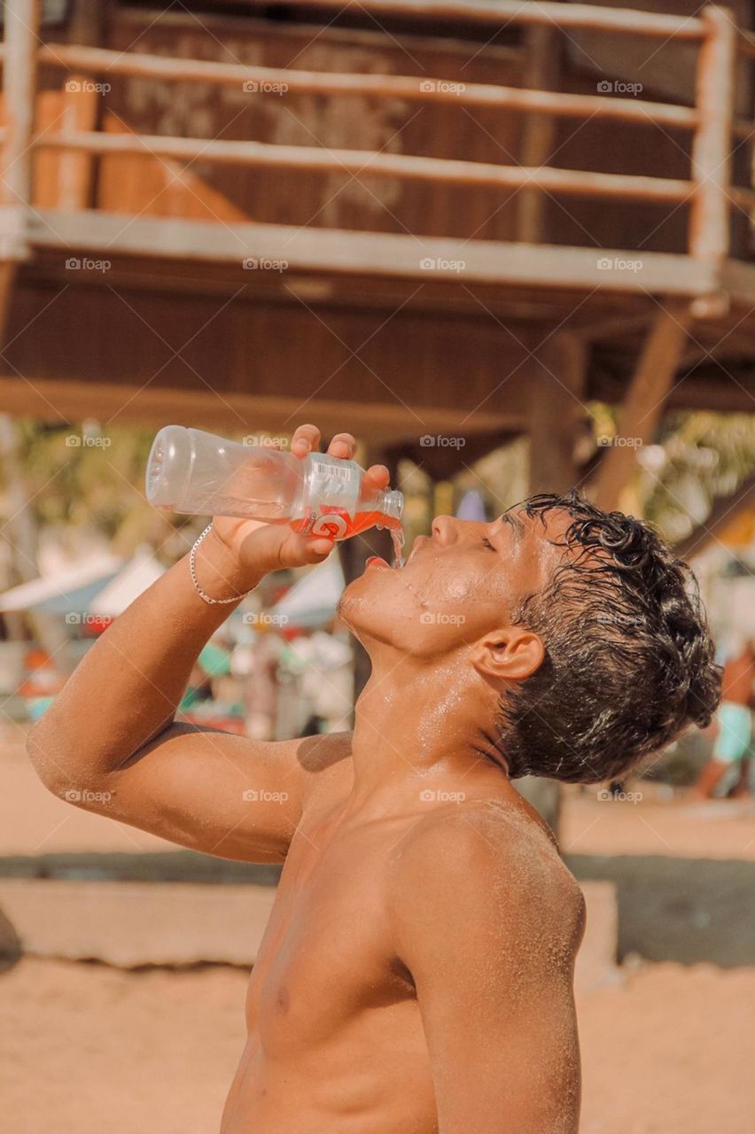 An Athlete getting hydrated after his training section