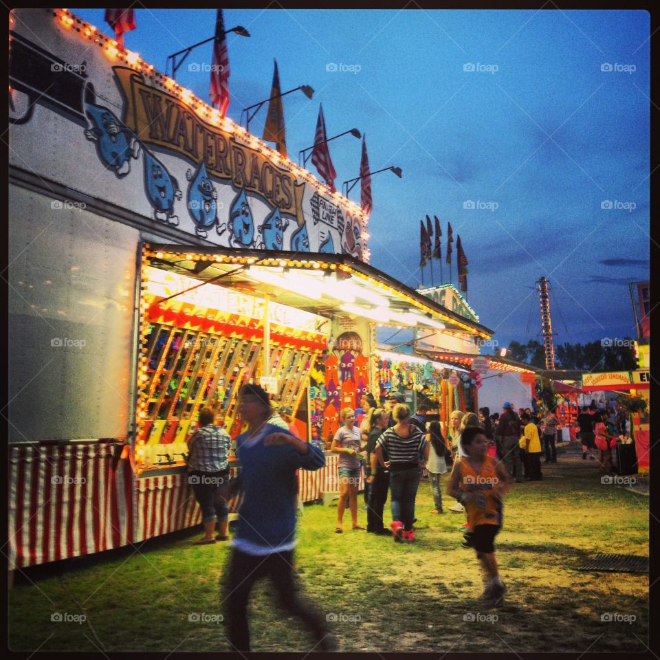Umatilla County Fair 2014. Kids running in front of carnival games at the Umatilla County Fair in 2014.
